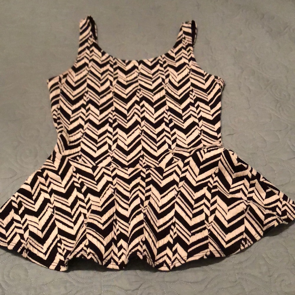 Sleeveless black and white print peplum top